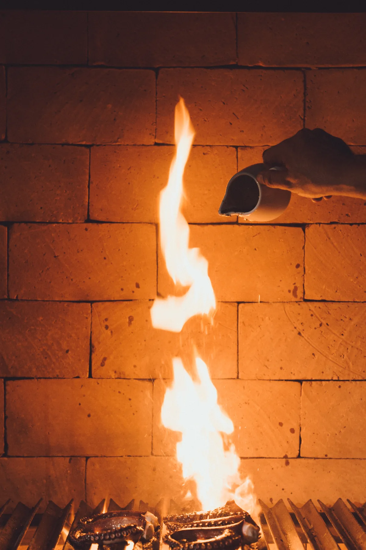 Flames rising in the wood-fired brick oven of the estate kitchen