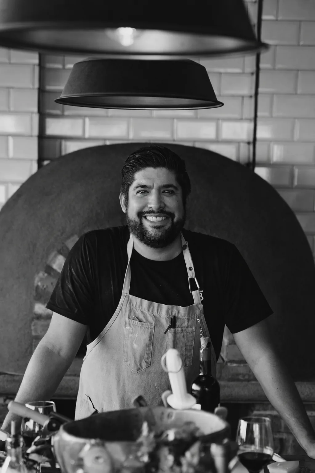 Chef Ubaldo Martínez at the wood-fired oven of the estate kitchen