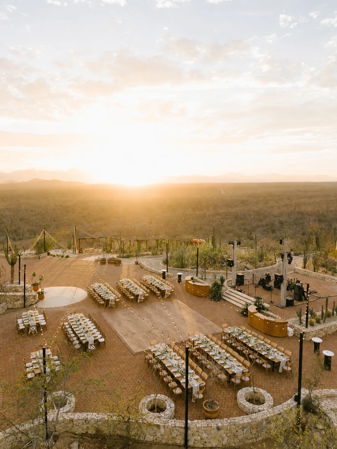 Aerial view of the estate terraces set for a celebration at sunset