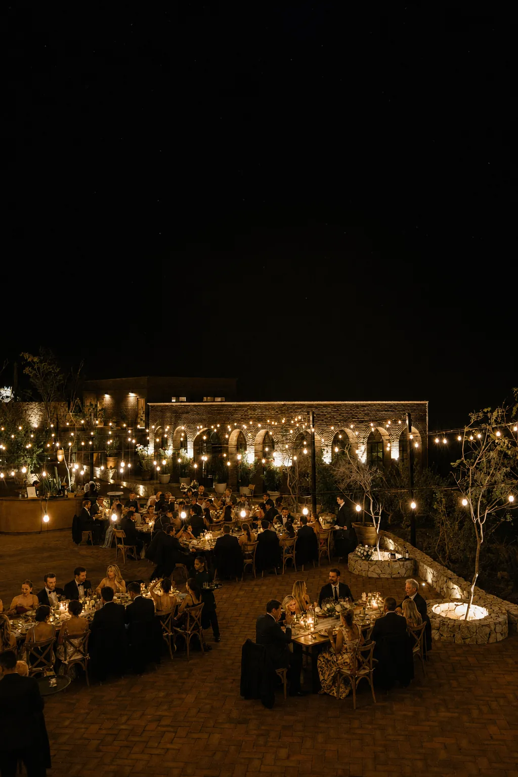 The reception lit against the dark desert, seen from above