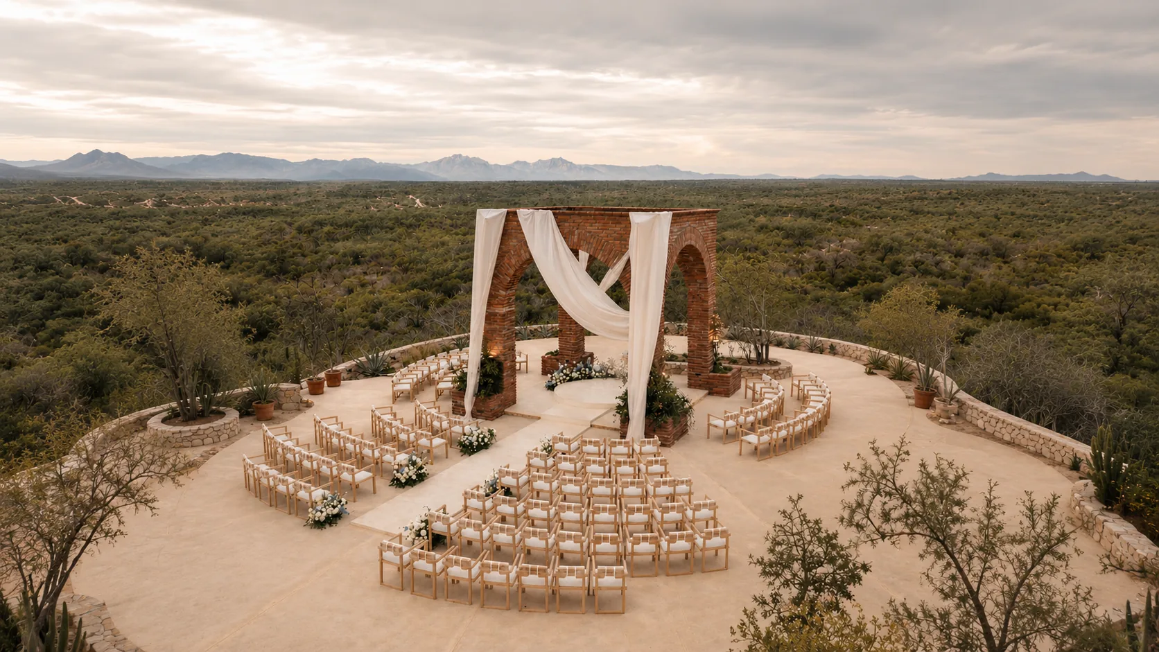Ceremony chairs set in a circle before the draped brick arch, seen from above