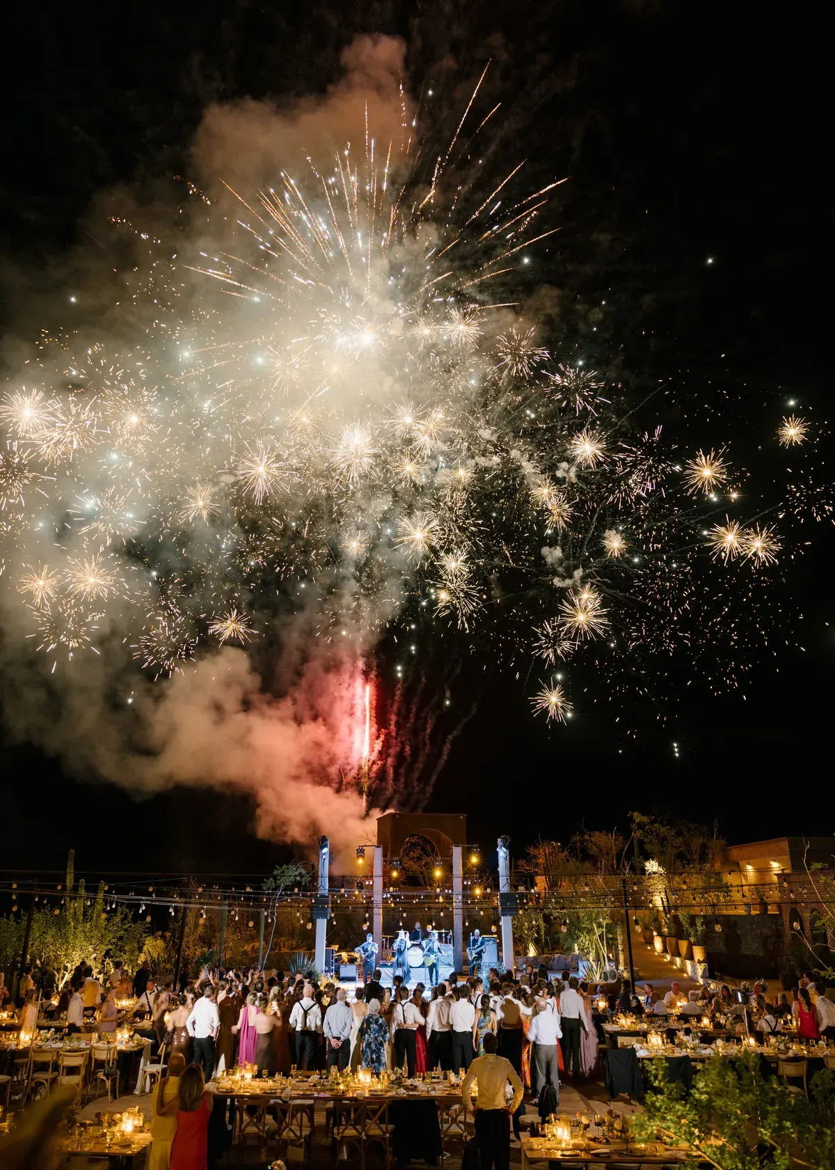 Fireworks over the estate as guests watch from the reception below
