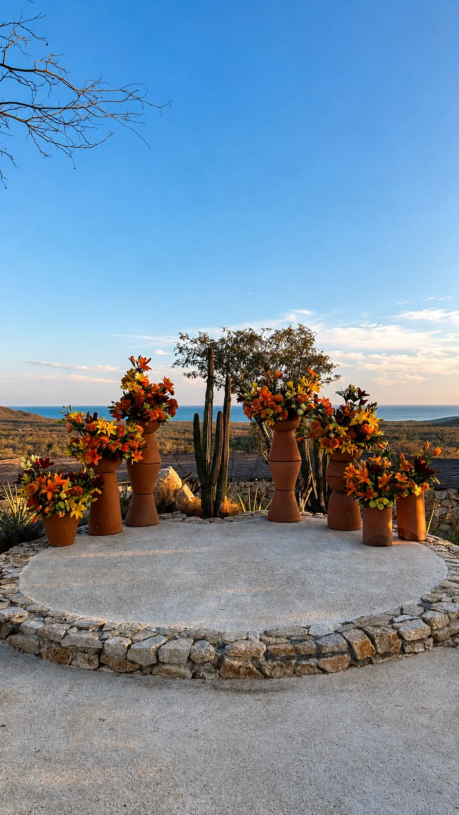 Ceremony platform ringed with terracotta pots of flowers above the Sea of Cortés