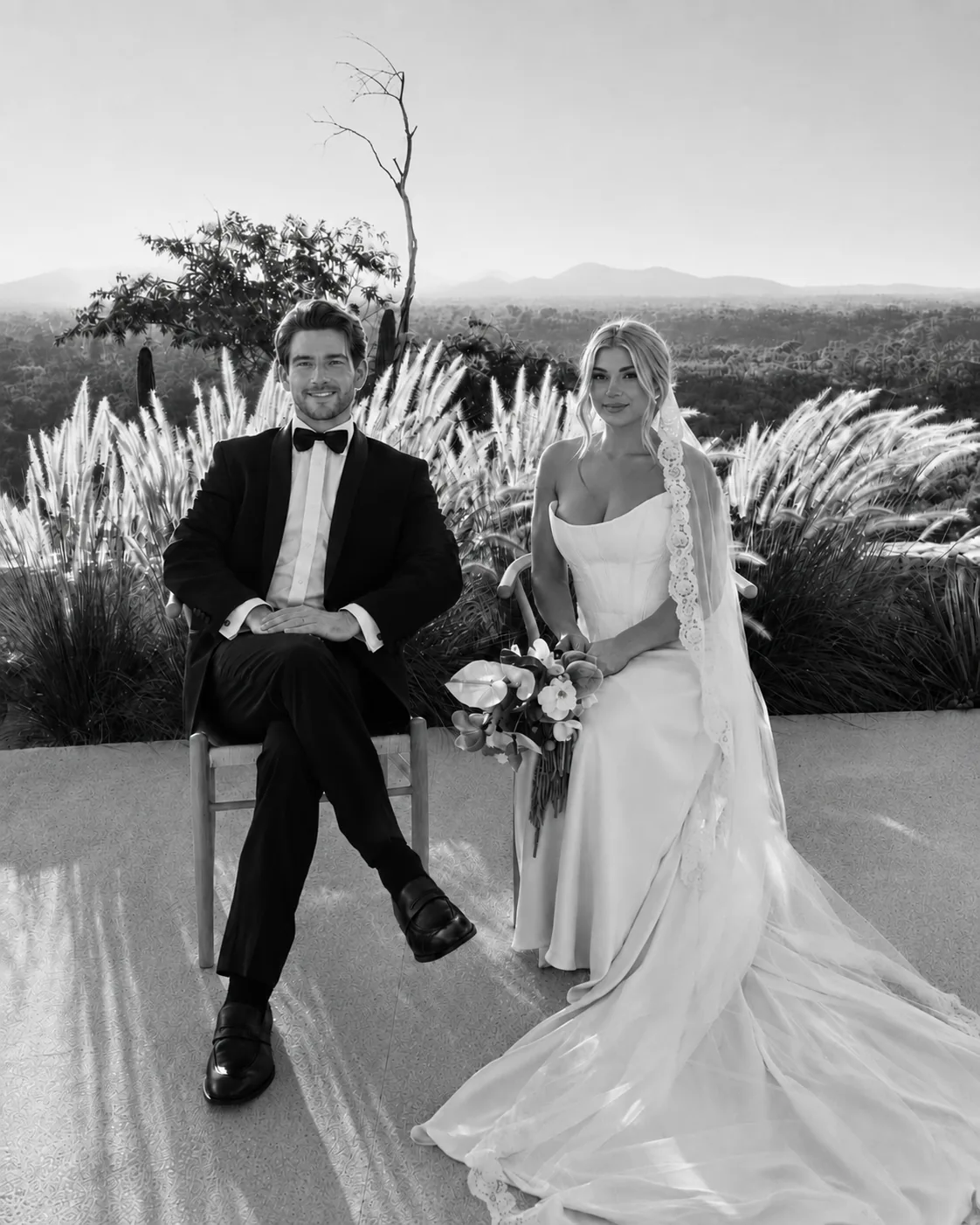 Bride and groom seated on the terrace among pampas grass